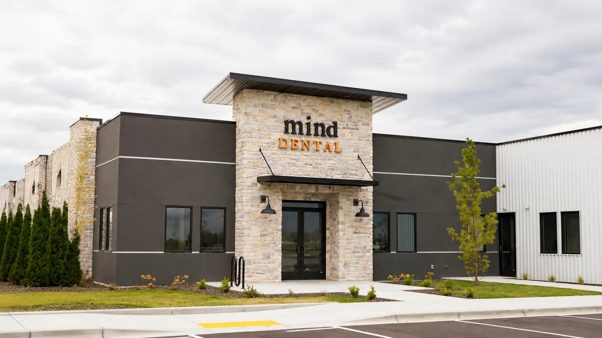 Mind Dental clinic exterior with modern stone and dark facade