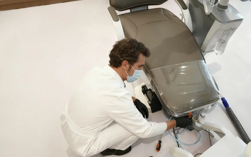 Technician installing and servicing a dental chair