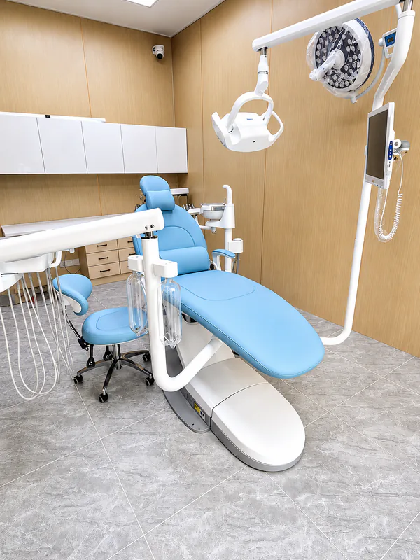 Guccidental B100L Ultra dental chair with overhead light in a treatment room